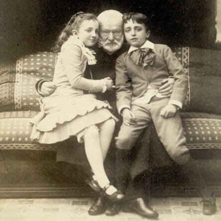  Photo de 1881 de Victor Hugo assis avec ses petits-enfants Georges et Jeanne, âgés d'environ 10 ans. 